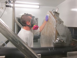 An HET technician cleans a bare Zerodur mirror segment.  The HET primary mirror has 91 such segments!